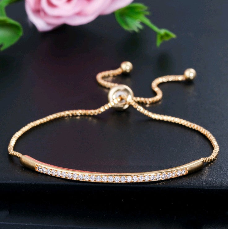 Single row curved bracelet with zircon and diamonds